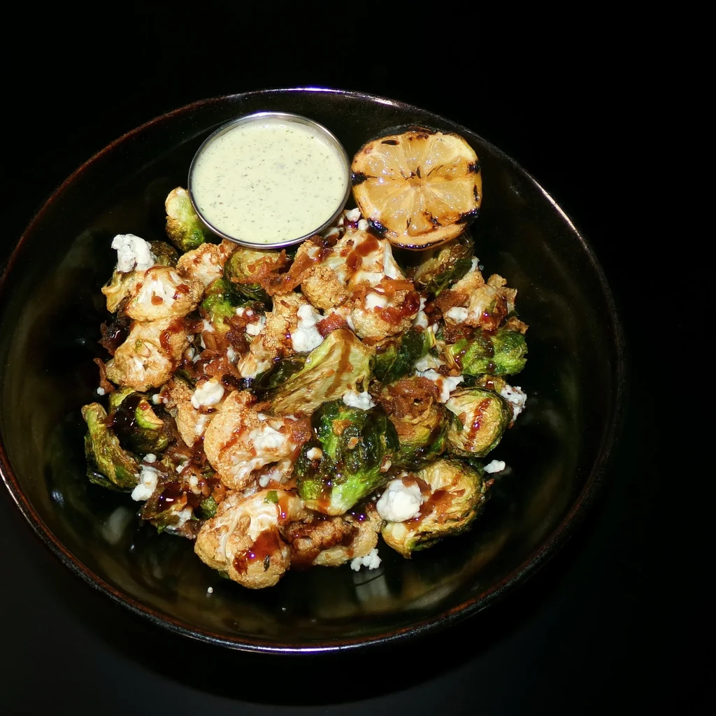 Charred roasted vegetables, cheese, balsamic glaze, grilled lemon, green dip.