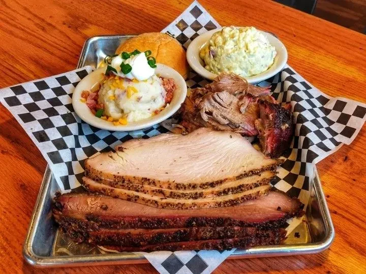Barbecue platter: smoked brisket, turkey, pulled meat, mashed potatoes, potato salad.