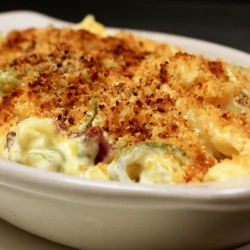Creamy baked dish topped with crispy breadcrumbs, vegetables, and meat.