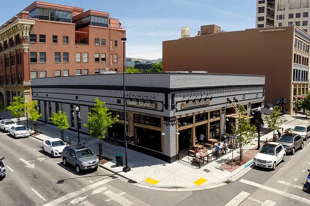 High-angle view of sunny 10 Barrel Brewing Co. building and patio.