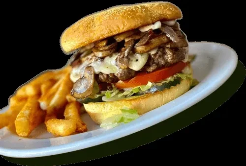 Gourmet burger with mushrooms, cheese, vegetables, and waffle fries.