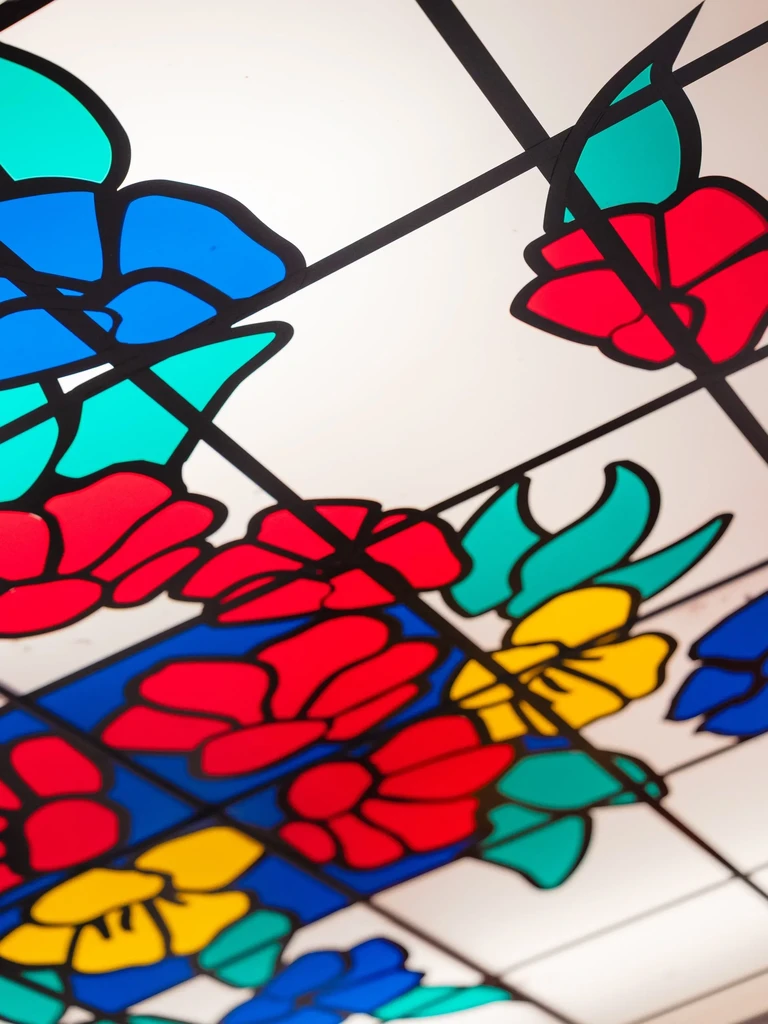 Colorful, stylized floral stained glass panel.