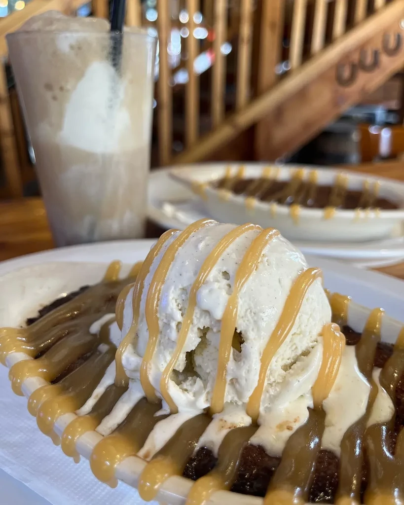 Warm chocolate dessert with vanilla ice cream and caramel sauce.