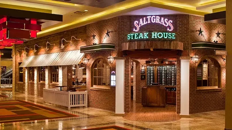 Indoor Saltgrass Steak House facade with rustic brick and Western decor.