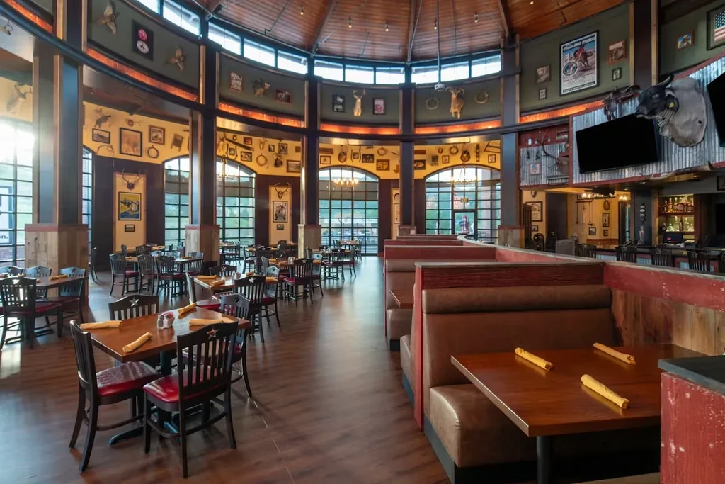 Empty, spacious rustic Western restaurant with vaulted wooden ceiling and taxidermy.