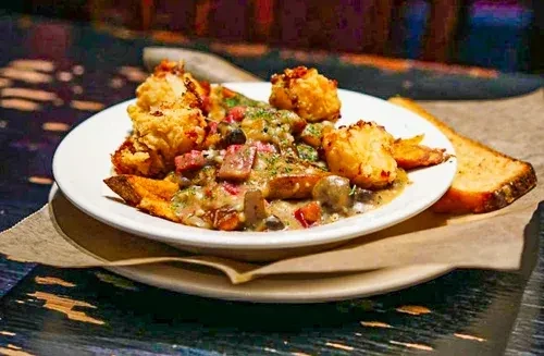Golden fried pieces, creamy mushroom-ham gravy, and toasted bread.