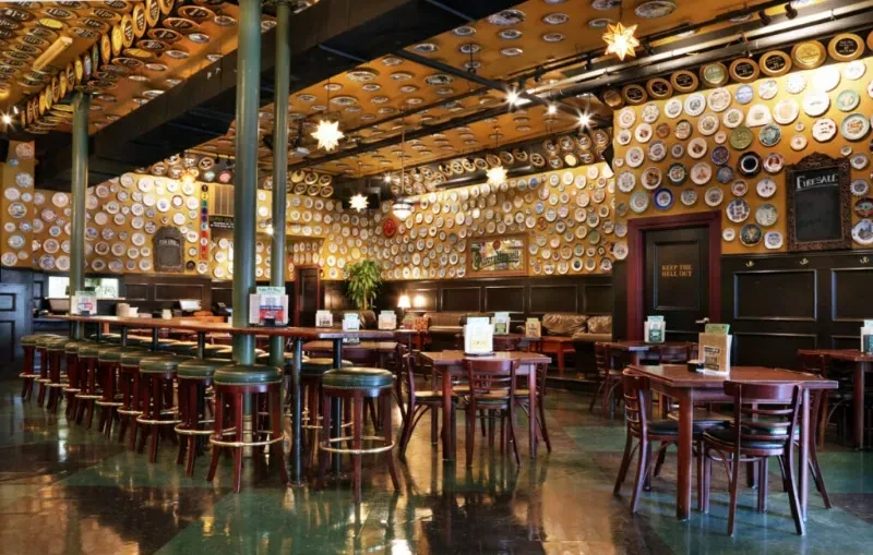 Eclectic restaurant interior with plate-covered walls and ceiling.