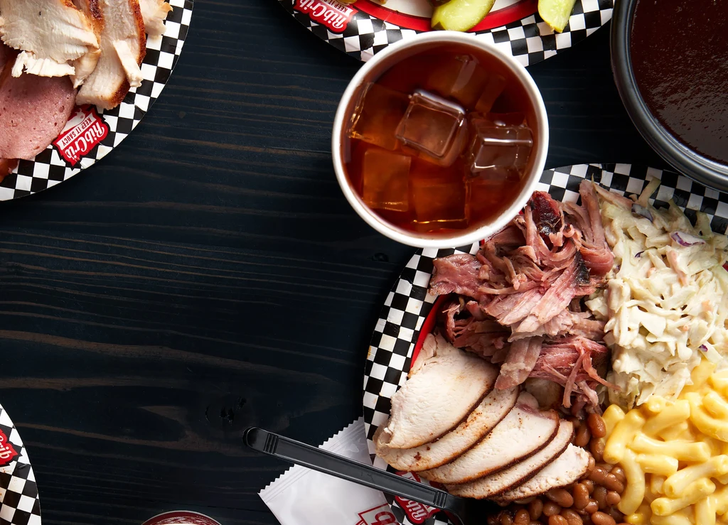 Overhead: Pulled pork barbecue plate with coleslaw, beans, macaroni.