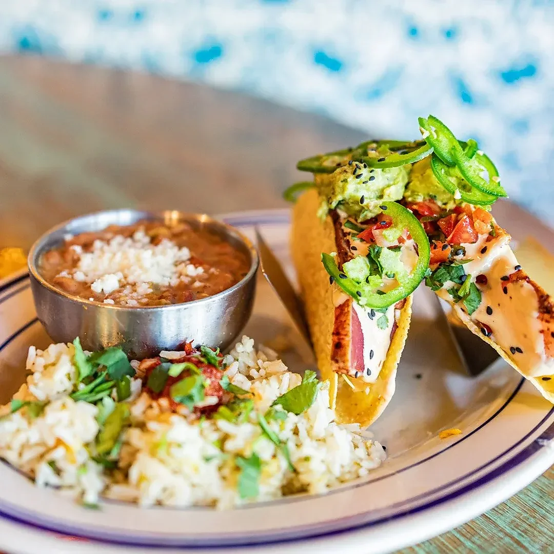 Seared tuna tacos with guacamole, jalapeno, rice and beans