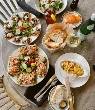 Top-down view of a restaurant table with diverse dishes and drinks.
