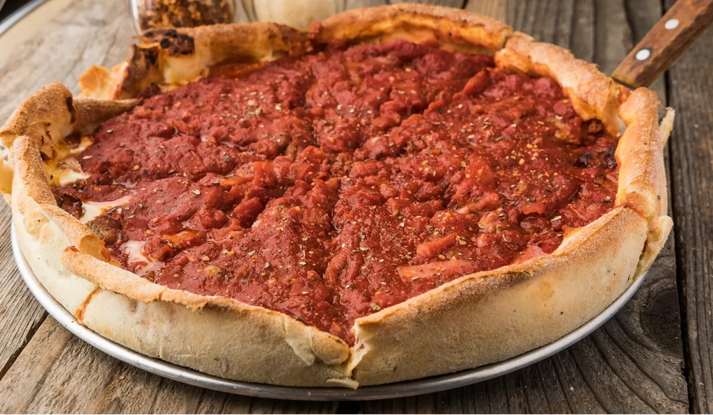 Freshly baked deep-dish pizza with red sauce, ready to serve.