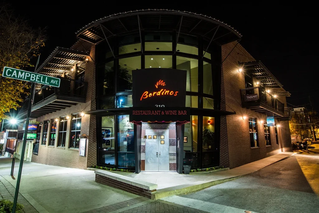 Modern Bordinos restaurant and wine bar, neon sign glowing at night.