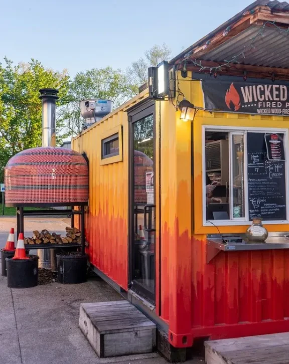 Wicked Wood-Fired Pizza in a flame-painted shipping container.