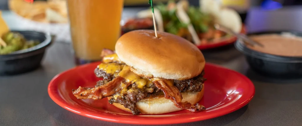 Double cheeseburger, melted cheese, bacon, with beer and guacamole.