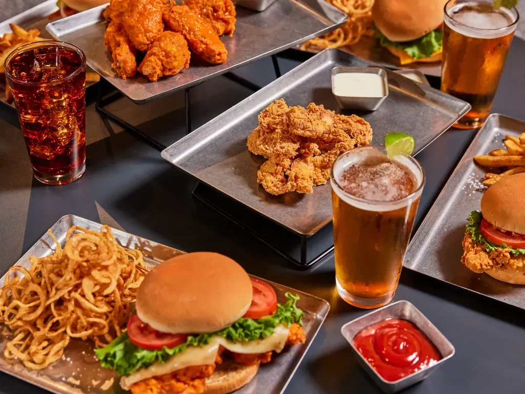 Metal trays hold a variety of casual dining food and beverages.