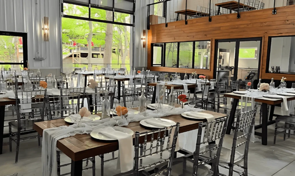 Spacious modern dining venue with set tables, clear chairs, and mezzanine.
