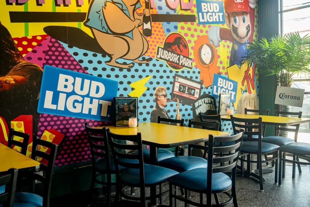 Vibrant restaurant interior with pop culture wall mural.