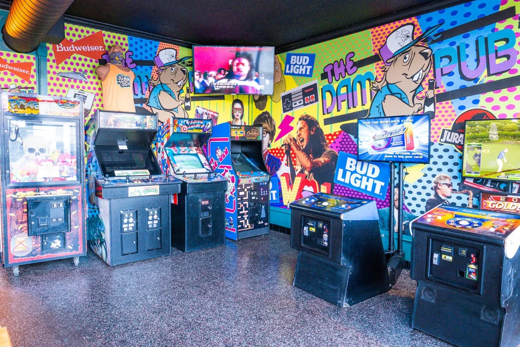 Arcade machines and retro pop art decor in The Dam Pub.