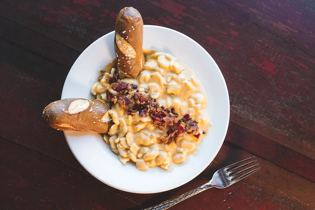 Creamy mac and cheese with bacon and salted pretzel breadsticks.