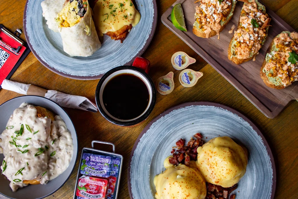 Diverse breakfast and brunch items like burritos, biscuits, toast, and eggs.
