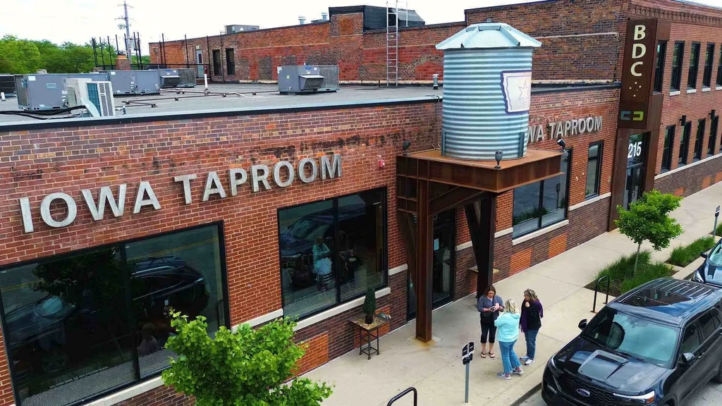 High-angle view: Iowa Taproom brick building with an elevated water tank.