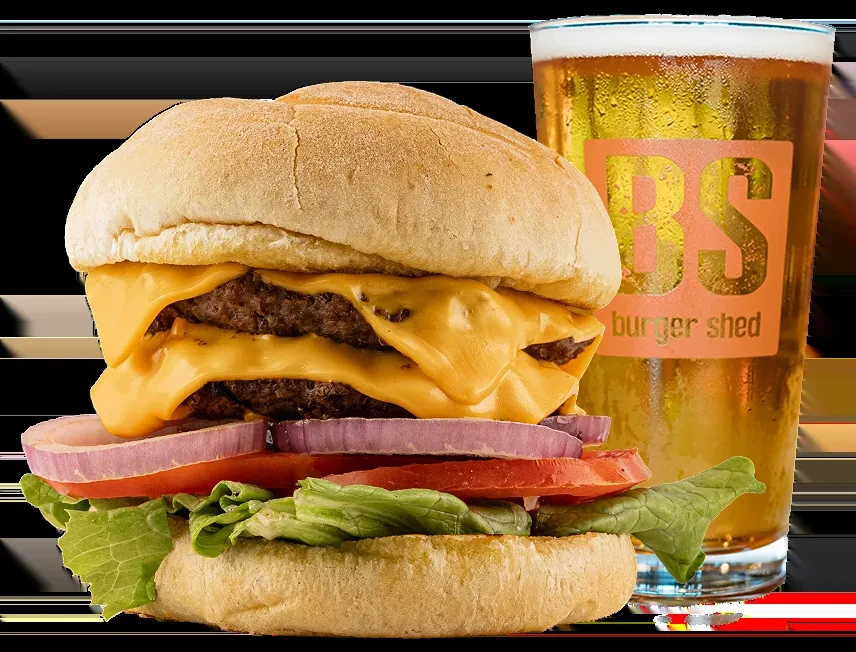 Double cheeseburger with melted cheese next to a frosty beer glass.