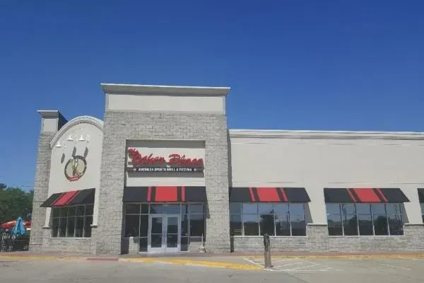Pakan Place Sports Grill and Pizzeria building, striped awnings.