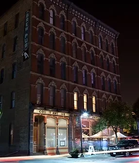 Brew pub on Court Avenue with ornate brick and patio at night.