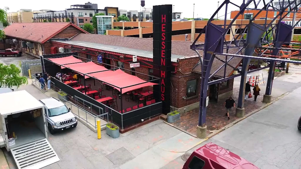 Hessen Haus brick restaurant with prominent sign and busy outdoor patio.