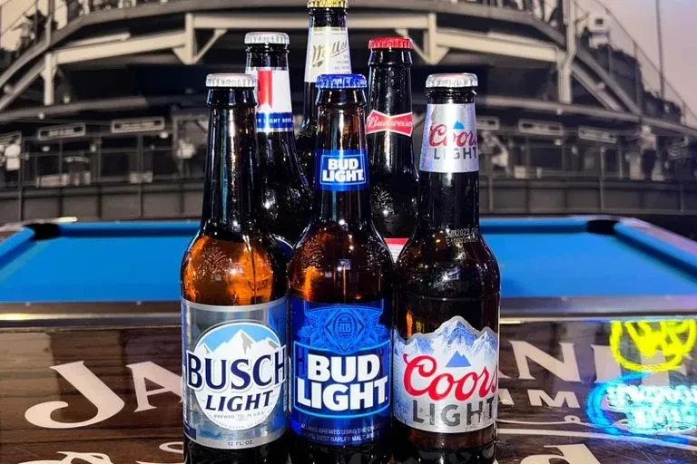 Bud, Coors, Miller, Busch beer bottles with a pool table.