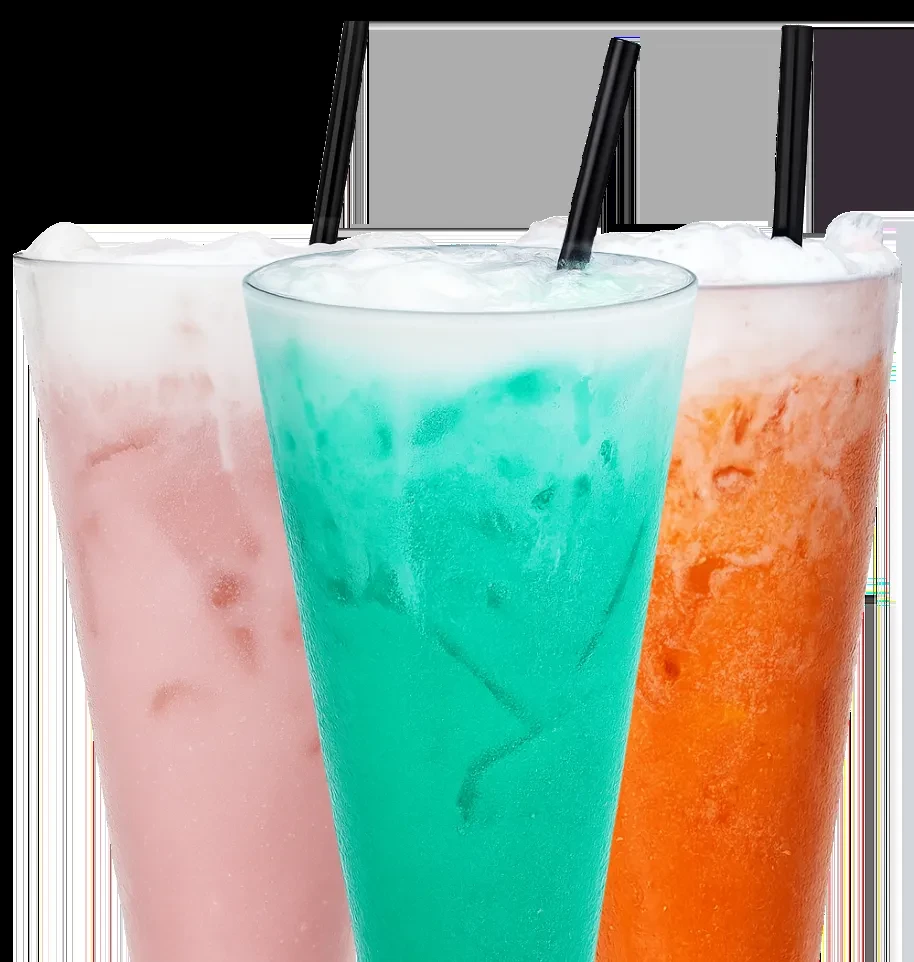 Three icy pink, teal, and orange drinks with foam and straws.