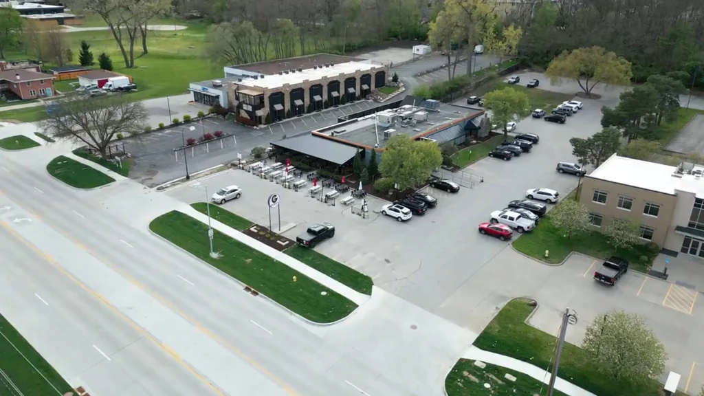 Aerial view of a restaurant with patio and another commercial building.