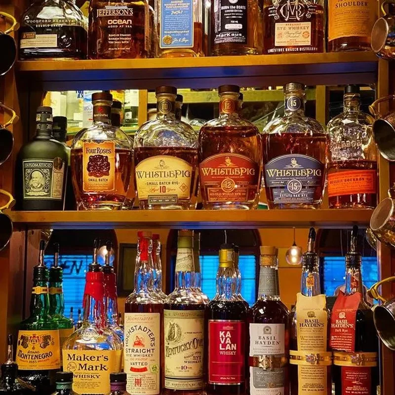 Wooden shelves showcasing a well-stocked collection of premium whiskies and spirits.