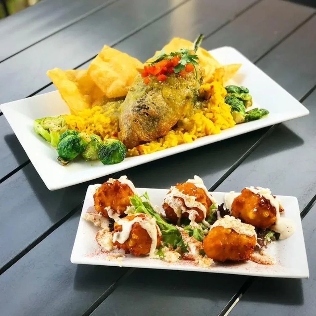 Two plates: battered chili relleno-like item, rice, and five fried fritters.