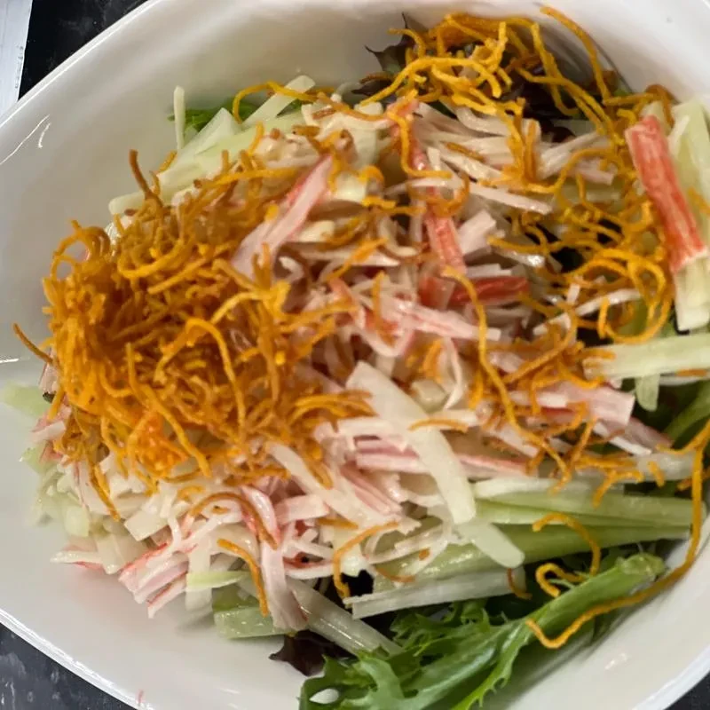 Salad with imitation crab, mixed greens, and crispy noodles.