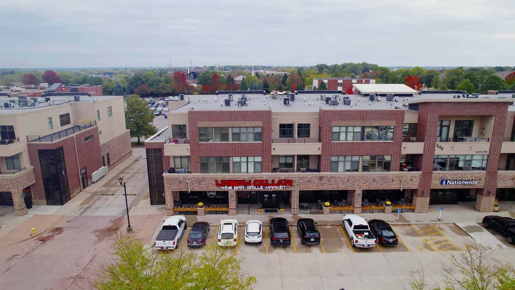 Overcast aerial view of URBAN CELLAR Wine Bar Grille Market complex.