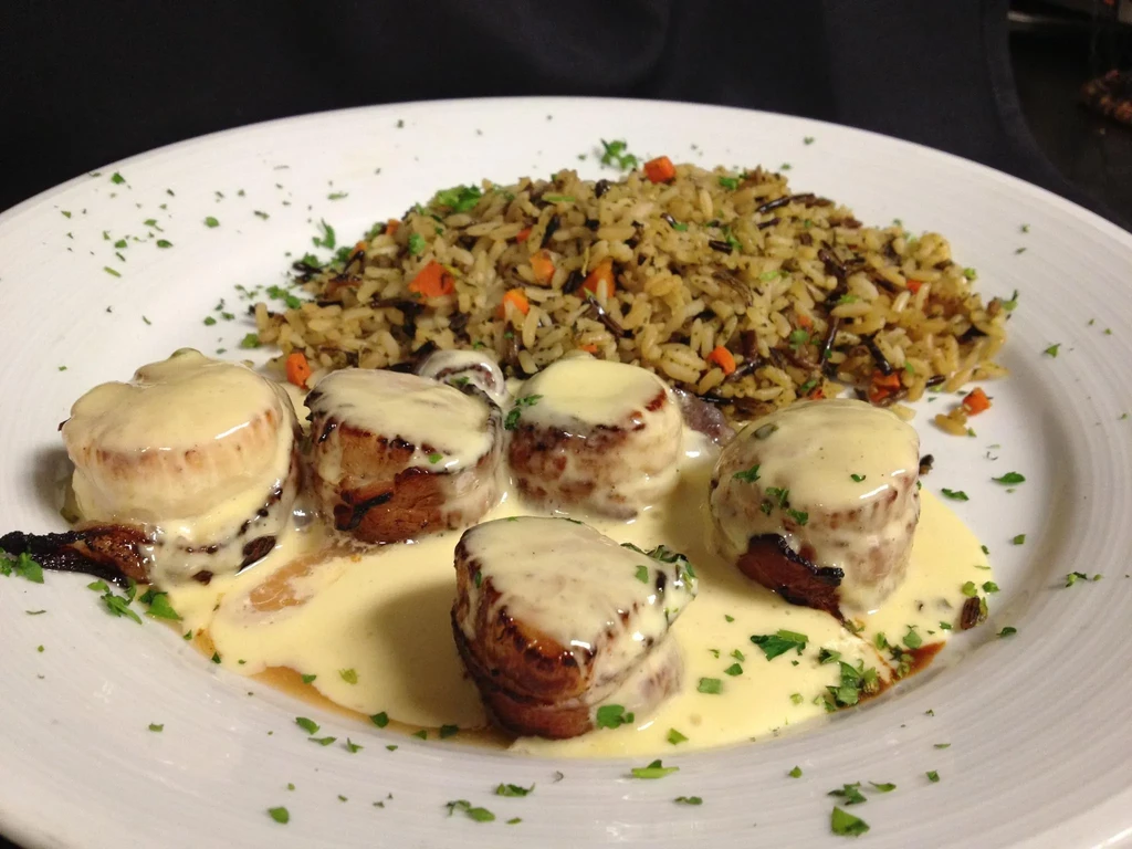 Five pan-seared medallions with creamy sauce, herbs, and rice pilaf.