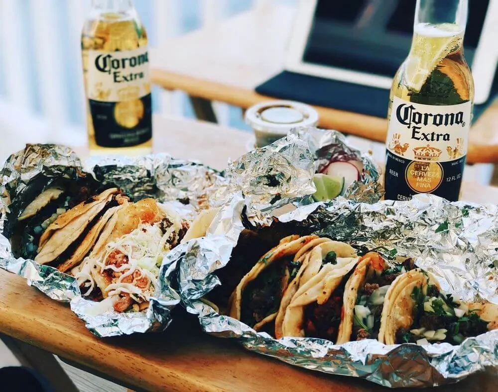 Close-up of street tacos and two Corona beers with lime.
