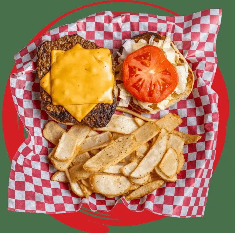 Open cheeseburger with fries on checkered paper against a green background.