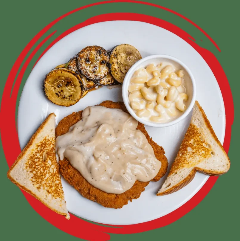 Complete meal: breaded cutlet with gravy, zucchini, mac and cheese, toast.