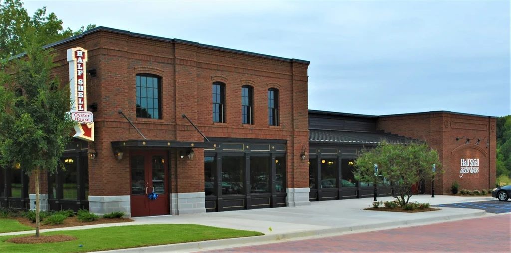 Red brick Half Shell Oyster House exterior with vertical and horizontal signs.