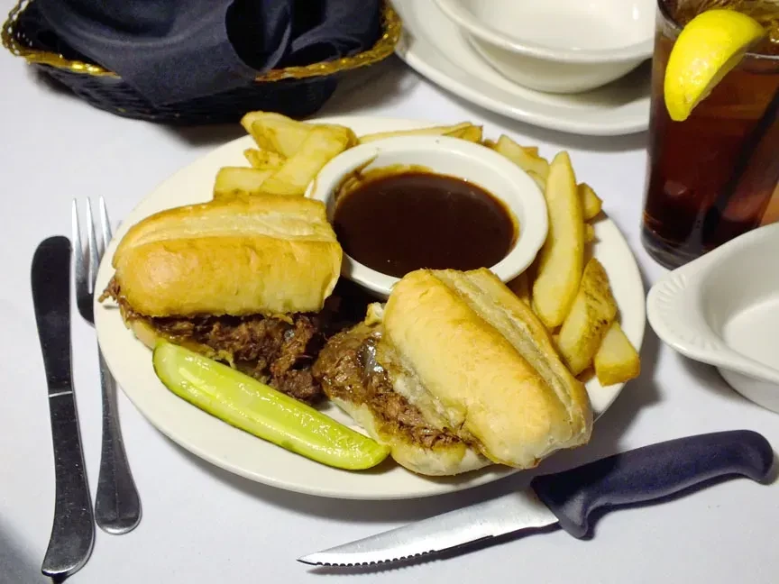 French dip sliders, steak fries, au jus, and a pickle spear.