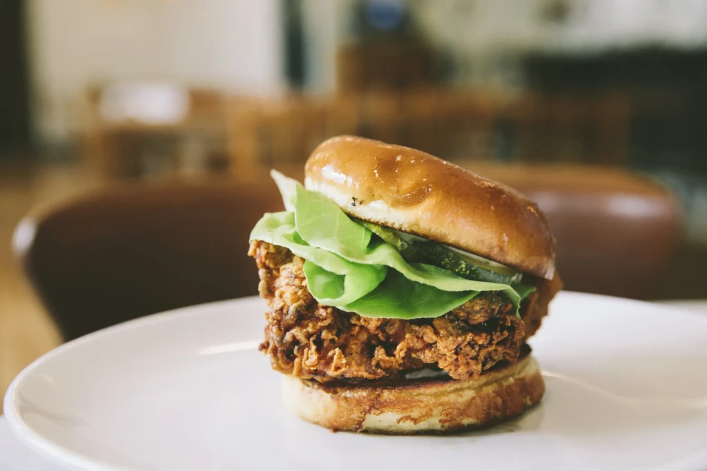 Crispy fried chicken sandwich on brioche with lettuce and pickles.