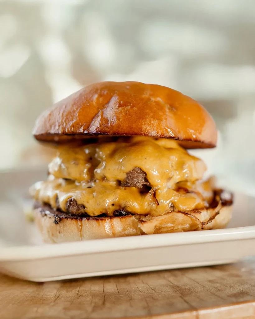 A double cheeseburger with two patties and gooey melted cheese.