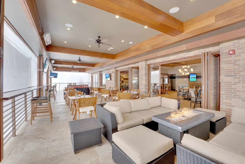 Modern outdoor restaurant patio with fire pit, lounge, and dining.