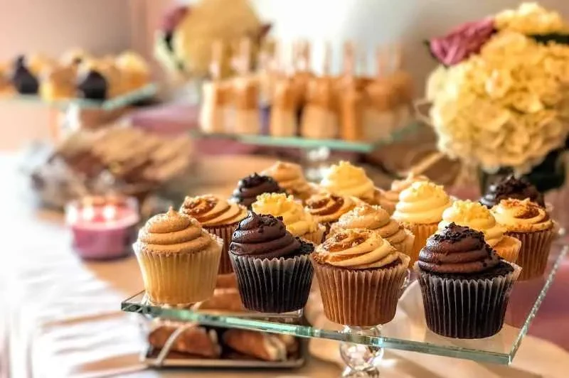 Tiered stand featuring assorted cupcakes at a dessert party.