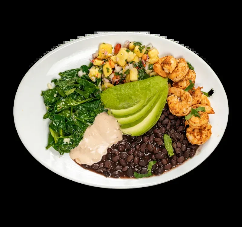 Plate with shrimp, black beans, greens, avocado, and fruit salsa.