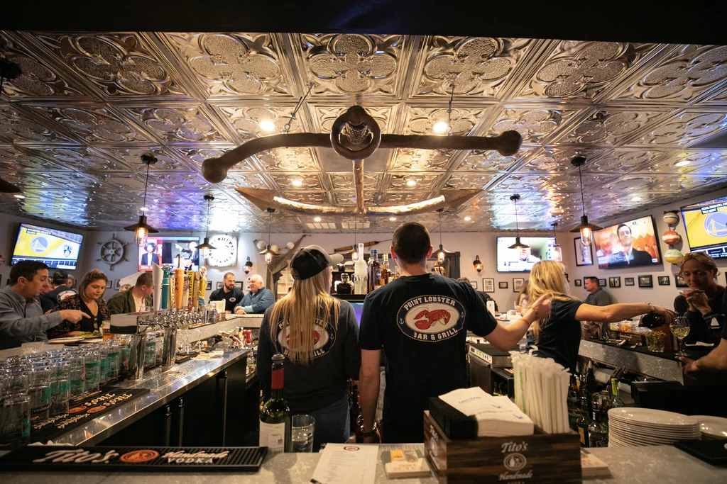 Vibrant, nautical-themed Point Lobster Bar & Grill with customers and staff.