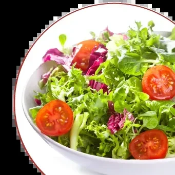 Vibrant mixed green salad with tomatoes and radicchio in white bowl.