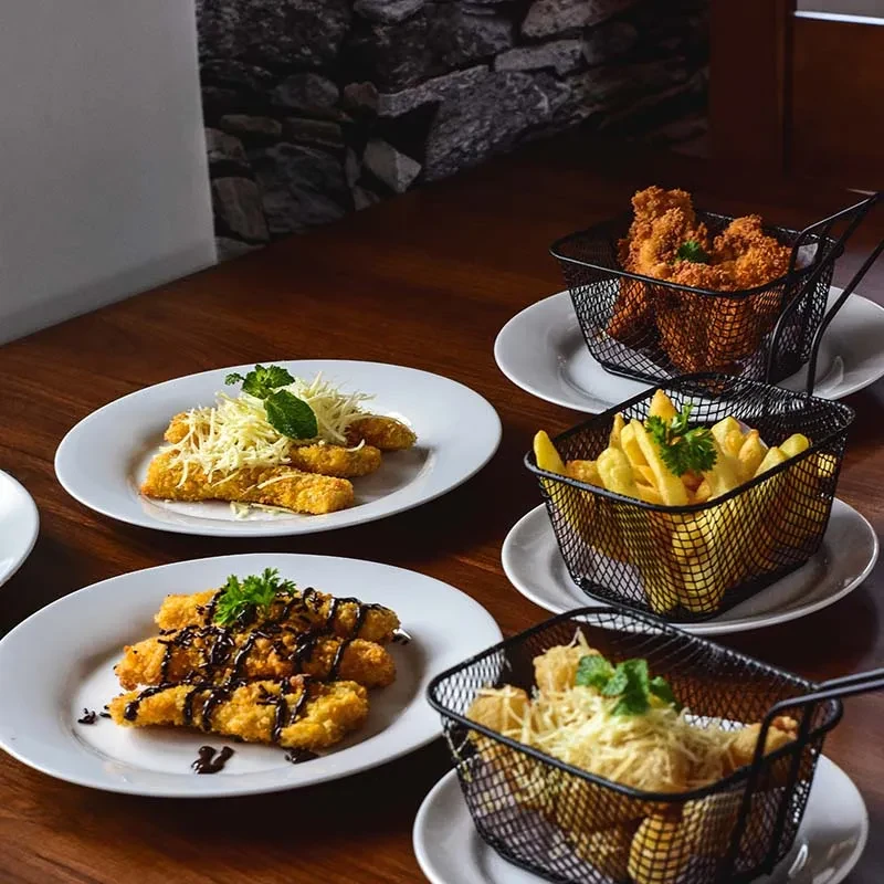 Fried chicken, french fries, and assorted fried snacks on a table.